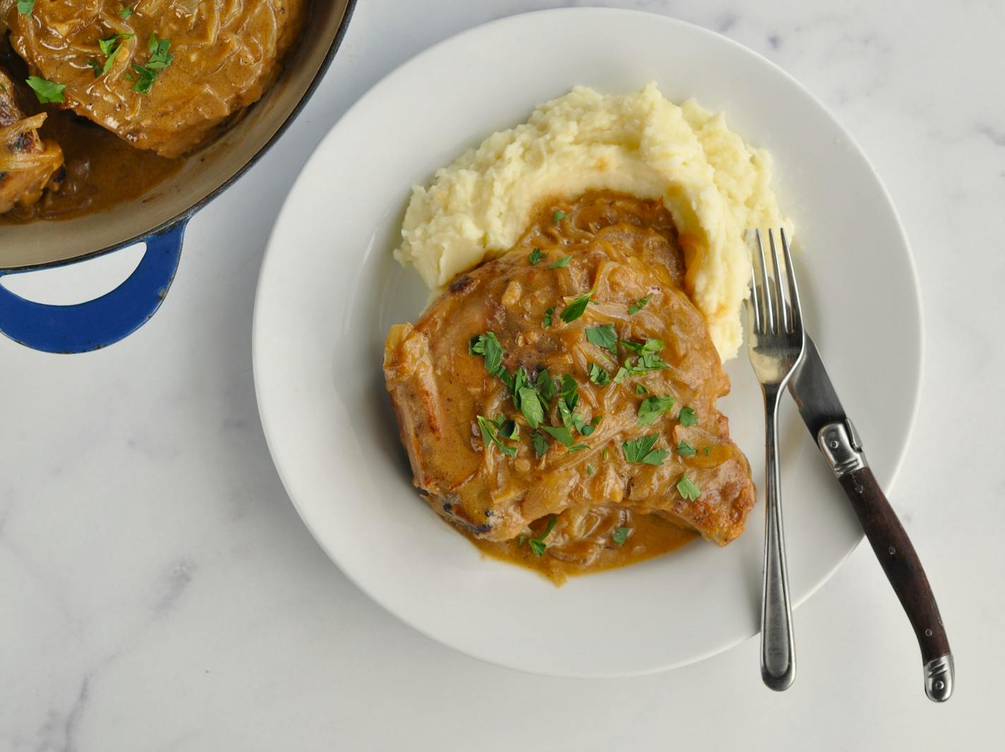 Pork chops are smothered in a maple-mustard sauce and served with mashed potatoes.