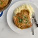Pork chops are smothered in a maple-mustard sauce and served with mashed potatoes.