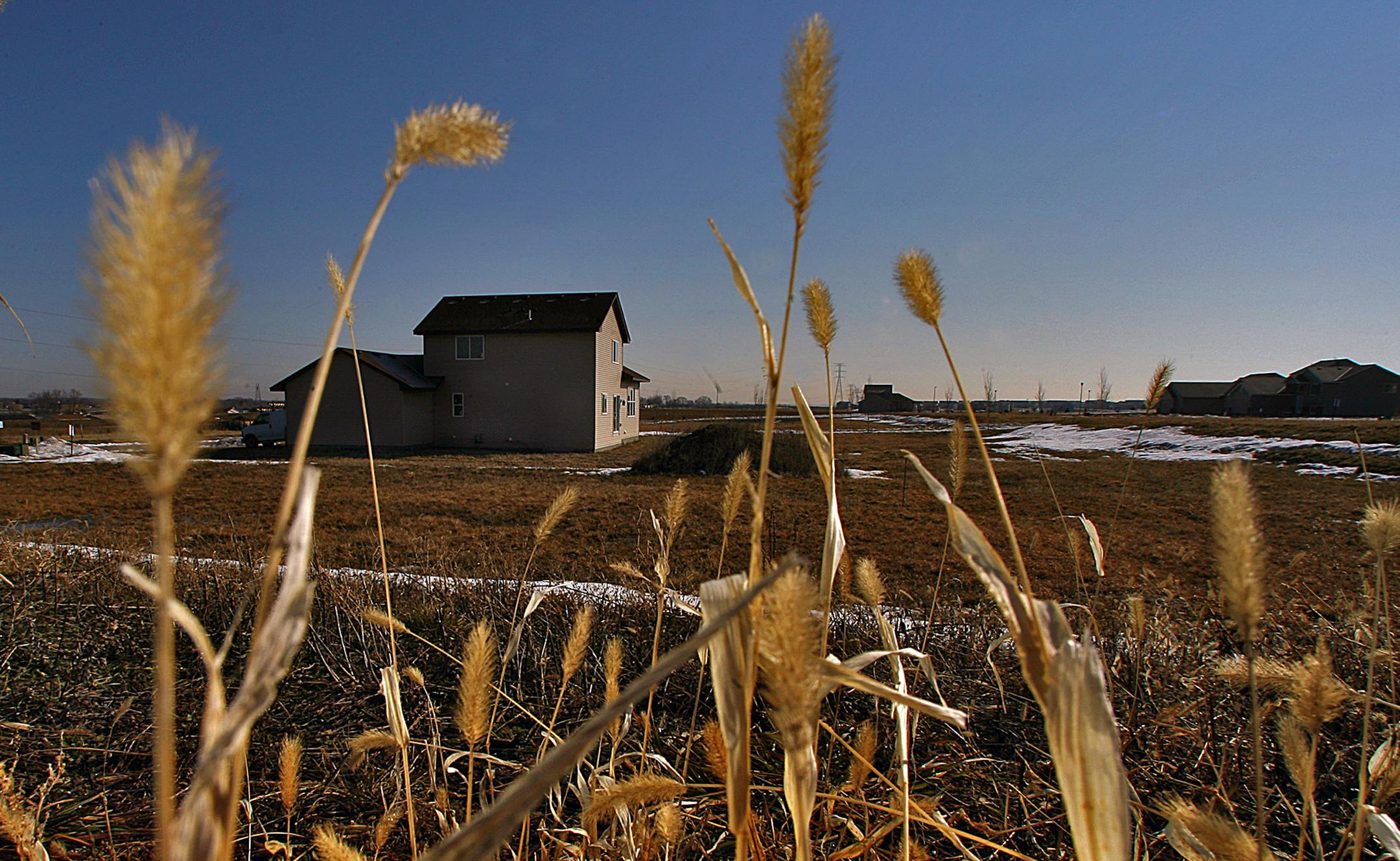 Homes under construction, like this one surrounded by lots for sale in a subdivision in Shakopee, are becoming a less-common sight in Twin Cities suburban counties than they have been in the past.