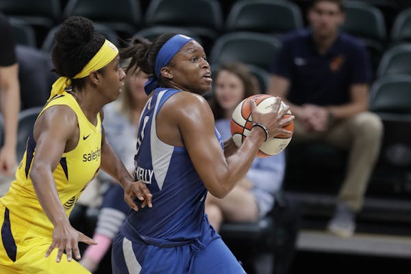 Minnesota Lynx's Karima Christmas-Kelly (0) drives to the basket against Indiana Fever's Shenise Johnson during the first half of a WNBA basketball ga