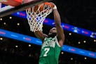 Celtics guard Jaylen Brown dunks the ball during the first half of Game 5 of the NBA Finals against the Mavericks on Monday, June 17, 2024, in Boston.