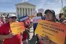 FILE - In this April 23, 2019 file photo, immigration activists rally outside the Supreme Court as the justices hear arguments over the Trump administ