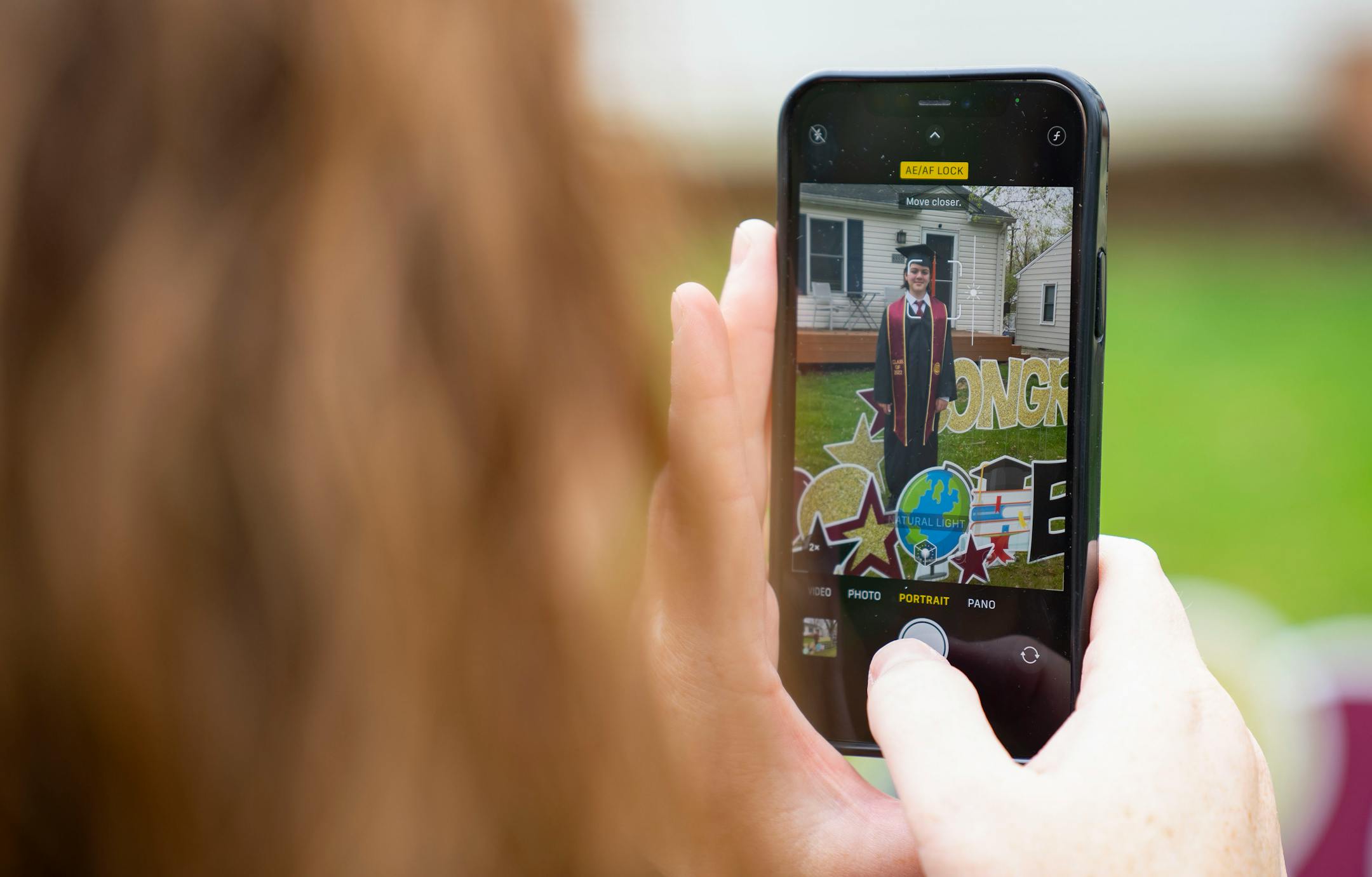 Michelle Tanner takes photos of her son, Elliott, 13, before his graduation.