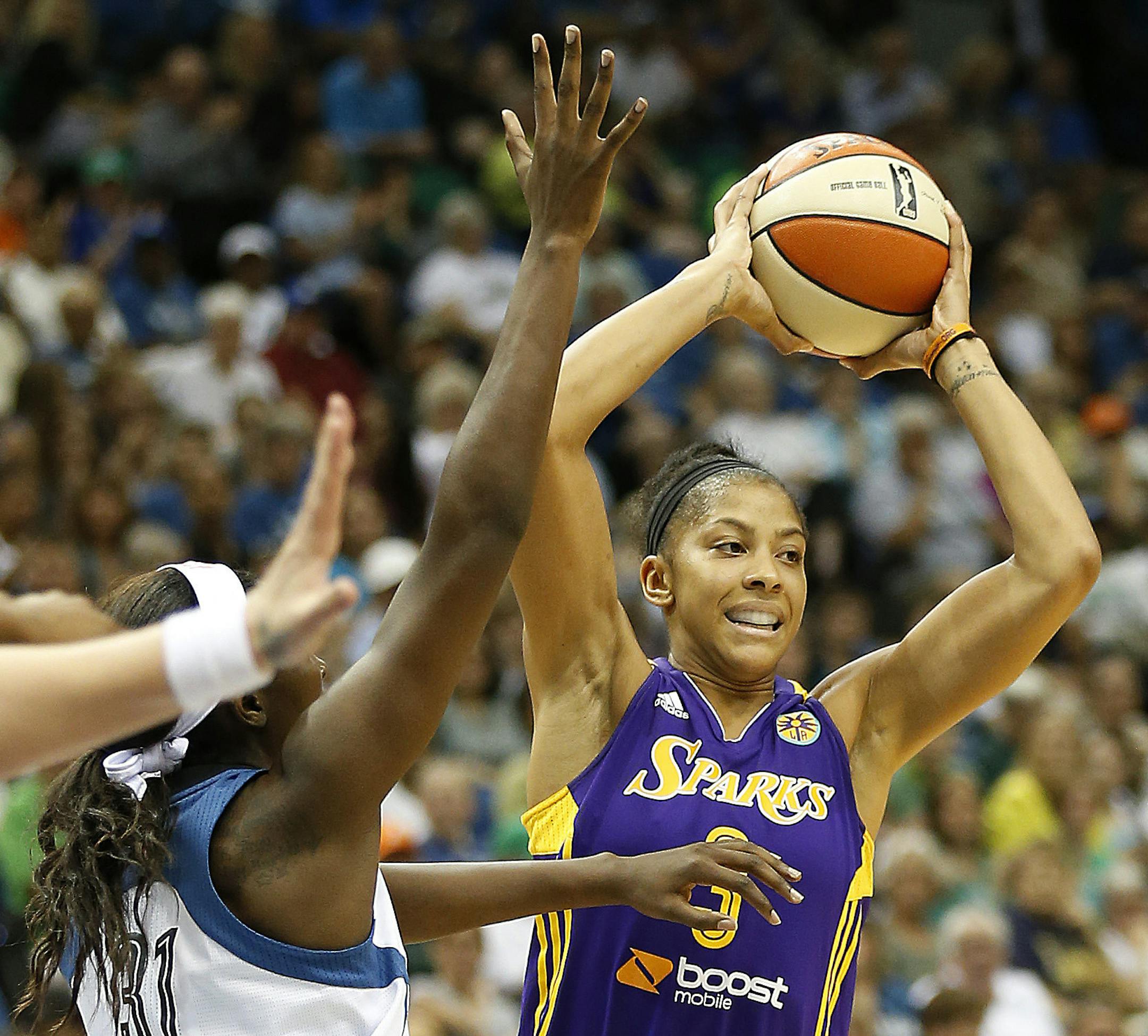 Los Angeles Sparks forward Candace Parker (3) looks to pass the ball against Minnesota Lynx forward Asia Taylor (31) in the first half of a WNBA basketball game, Tuesday, Aug. 12, 2014, in Minneapolis. (AP Photo/Stacy Bengs)