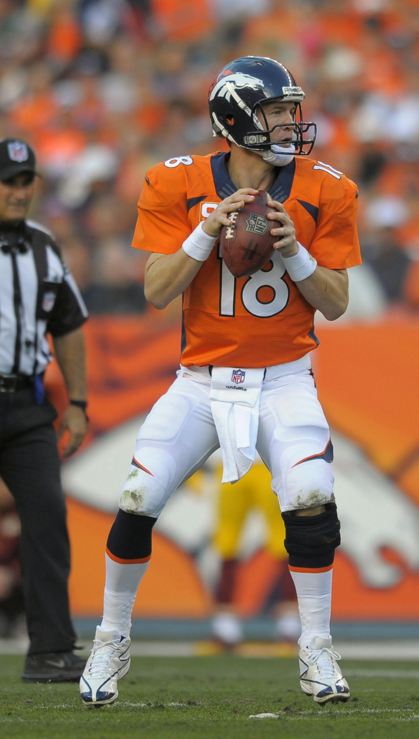 Denver Broncos quarterback Peyton Manning (18) steps back to pass against the Washington Redskins in the third quarter of an NFL football game, Sunday, Oct. 27, 2013, in Denver. (AP Photo/Jack Dempsey) ORG XMIT: COJJ278