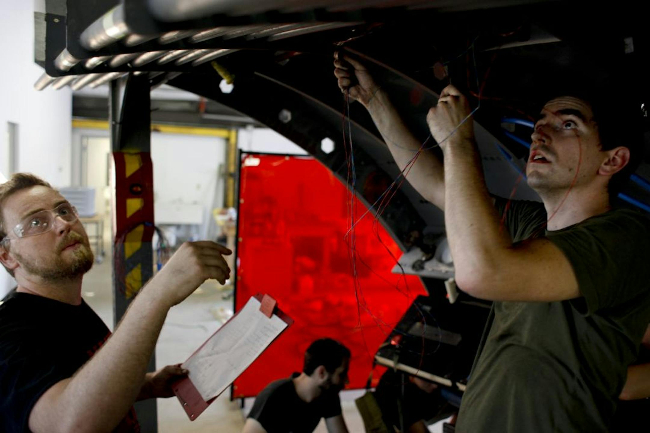 David and Jed Heisserer, continue wiring the "Hunt for Red September," a game conceived and built from scratch in 72 hours for this year's Red Bull competition"The game of games" in Minneapolis, Minn. on Sunday, July 22, 2012. About a dozen of engineers, artists, designers and friends are collaborating to win the national competition.