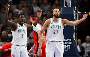 Minnesota Timberwolves guard Anthony Edwards (5) and Minnesota Timberwolves center Rudy Gobert (27) argue a foul called against Gobert in the second h