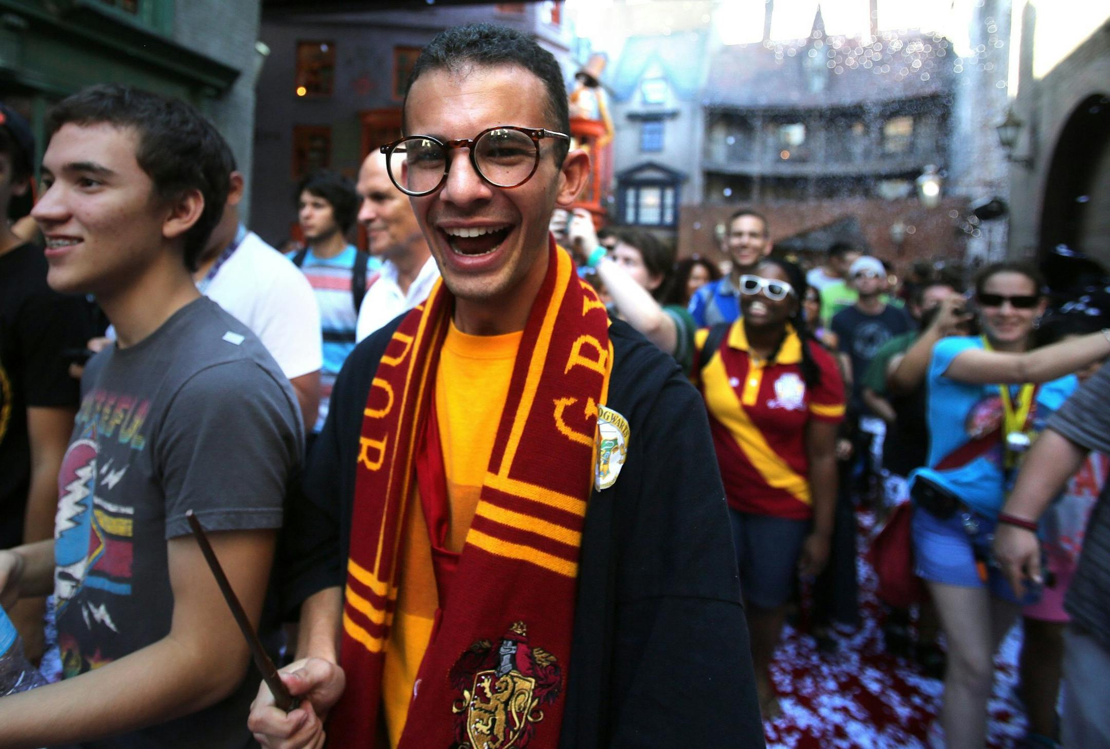 Cheering fans react to being welcomed into a confetti-filled Diagon Alley during the grand opening at the Wizarding World of Harry Potter expansion, at Universal Studios Florida, in Orlando, Tuesday, July 8, 2014. (Joe Burbank/Orlando Sentinel/MCT)