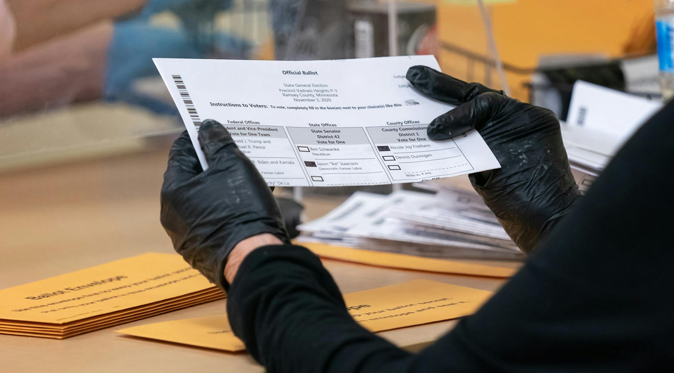 Election judge Janice Arenz checked ballots as she removed them from ballot envelopes. Ramsey County election judges processed early voting ballots a week before the election. After Ballots are removed from envelopes by separate teams to ensure privacy, they are scanned by computer, stored on memory sticks which are then counted after the polls close on election night. ] GLEN STUBBE • glen.stubbe@startribune.com Tuesday, October 27, 2020 Ramsey County election judges processed early voting ballo