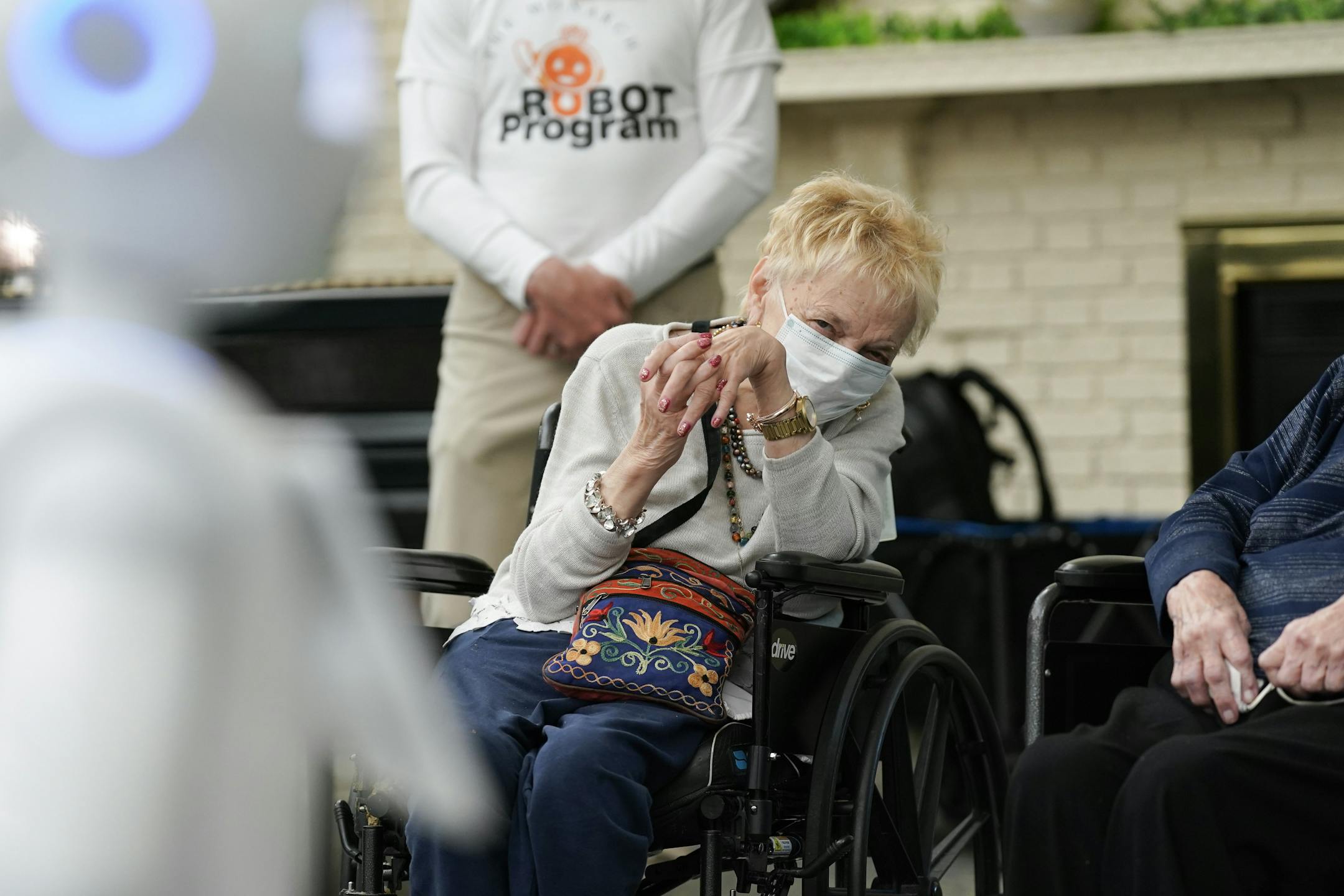 Nursing home residents Carol Jones listened as Pepper, a new robotic assistant, performed an adult-themed comedy routine about her electronic relationships.