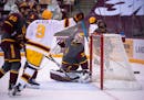 Minnesota Gophers center Sammy Walker (9) celebrated and Arizona State Sun Devils goaltender Evan Debrouwer (30) winced after he was scored on by Goph