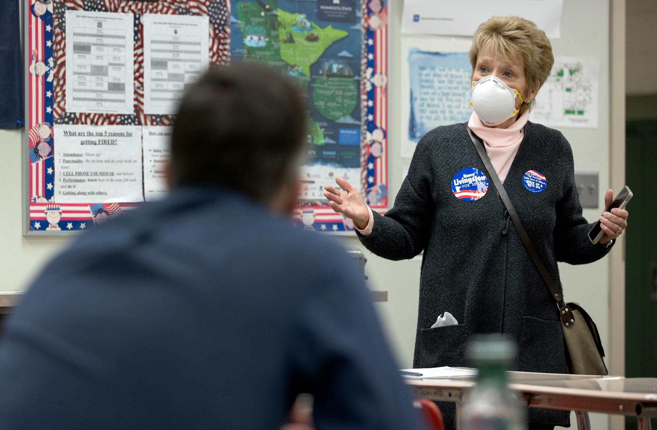 State Senate candidate Nancy Livingston speaks to a resident from North St. Paul precinct 2 during a DFL caucus Tuesday, Feb. 1, at North High School in North Saint Paul, Minn. ] CARLOS GONZALEZ • cgonzalez@startribune.com