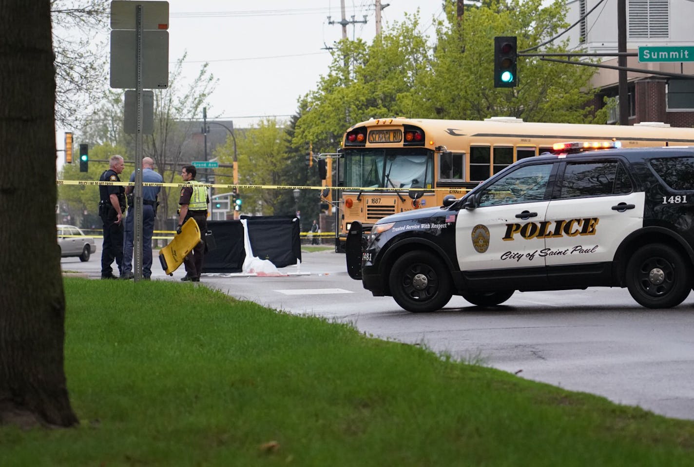 Police at the intersection of Snelling and Summit Avenues investigating a fatal crash involving a school bus and a bicyclist this afternoon.