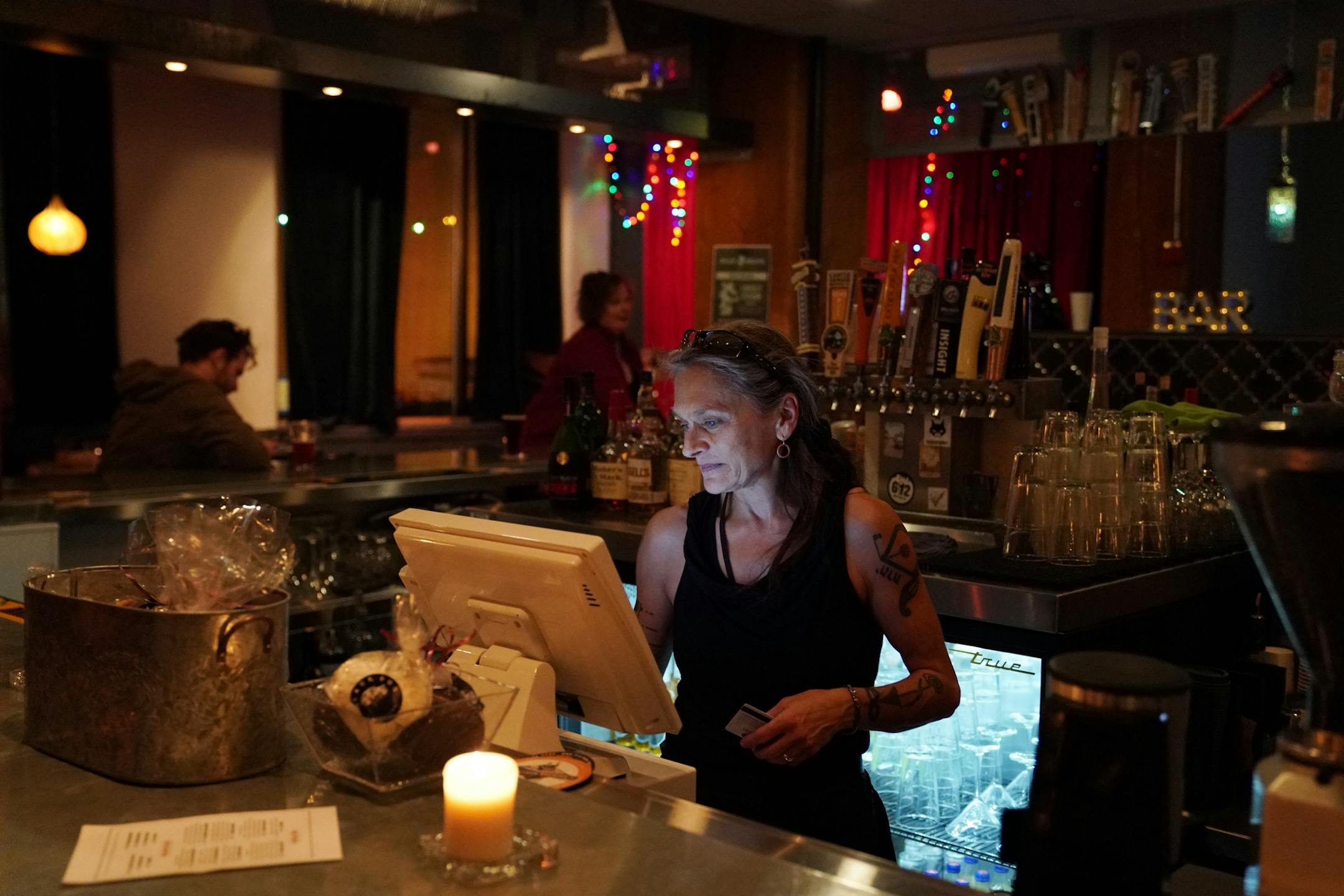 Bartender Eli Nielsen rang up an order un the blue glow of the computer's screen Saturday evening at the Black Dog Cafe.
