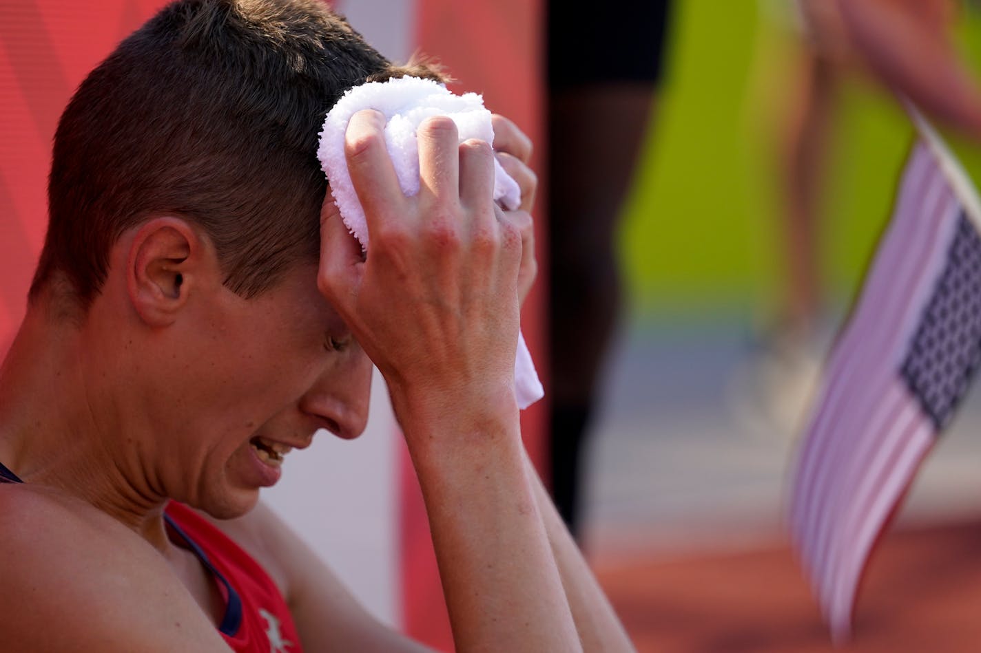 Mason Ferlic cools off with a cold towel after the finals of the men's 3000-meter steeplechase at the U.S. Olympic Track and Field Trials Friday, June 25, 2021, in Eugene, Ore. (AP Photo/Ashley Landis)