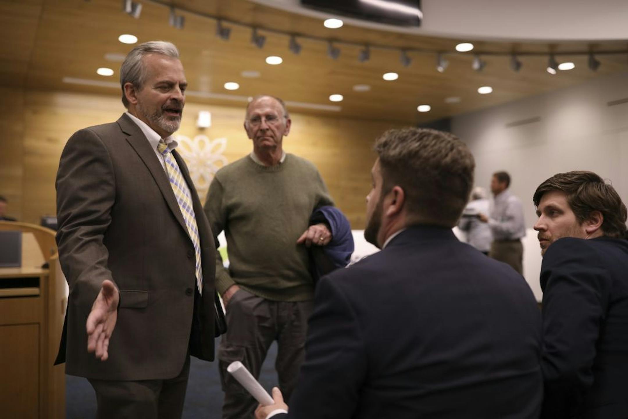 After the Forest Lake City Council failed to take action on the proposed amendment, Jeff Bradt, CEO and President of The Hills, left, spoke with Mark McLane of Krauss Anderson, who would be the developer of the project. Standing with Bradt is Ron Moore, the owner of Shadow Creek Stables. At right is Brandon Elegert of Kimley-Horn and Associates, civil engineers on the project.