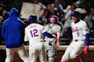 The Mets' Brandon Nimmo (9) celebrates with Francisco Lindor (12) and other teammates after hitting a walk-off, two-run homer to beat the Braves on Su