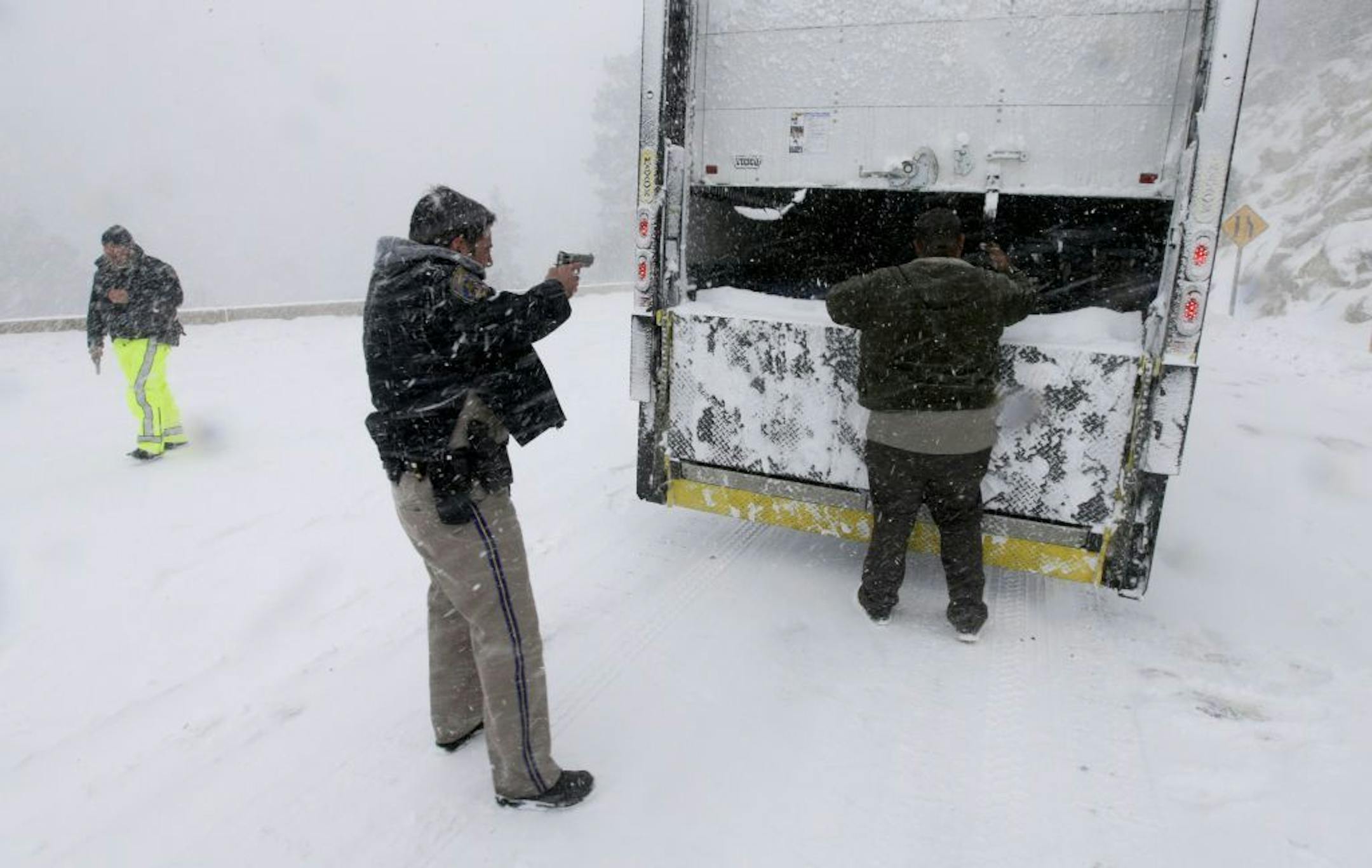 Members on the California Highway Patrol search a truck for Christopher Dorner, a former Los Angeles police officer accused of carrying out a killing spree because he felt he was unfairly fired from his job, Friday, Feb. 8, 2013, in Big Bear Lake, Calif.