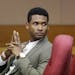 R&B singer Usher waits for a child custody hearing to begin, Friday, Aug. 9, 2013, in Atlanta. A judge in Atlanta is set to hear arguments in the chil