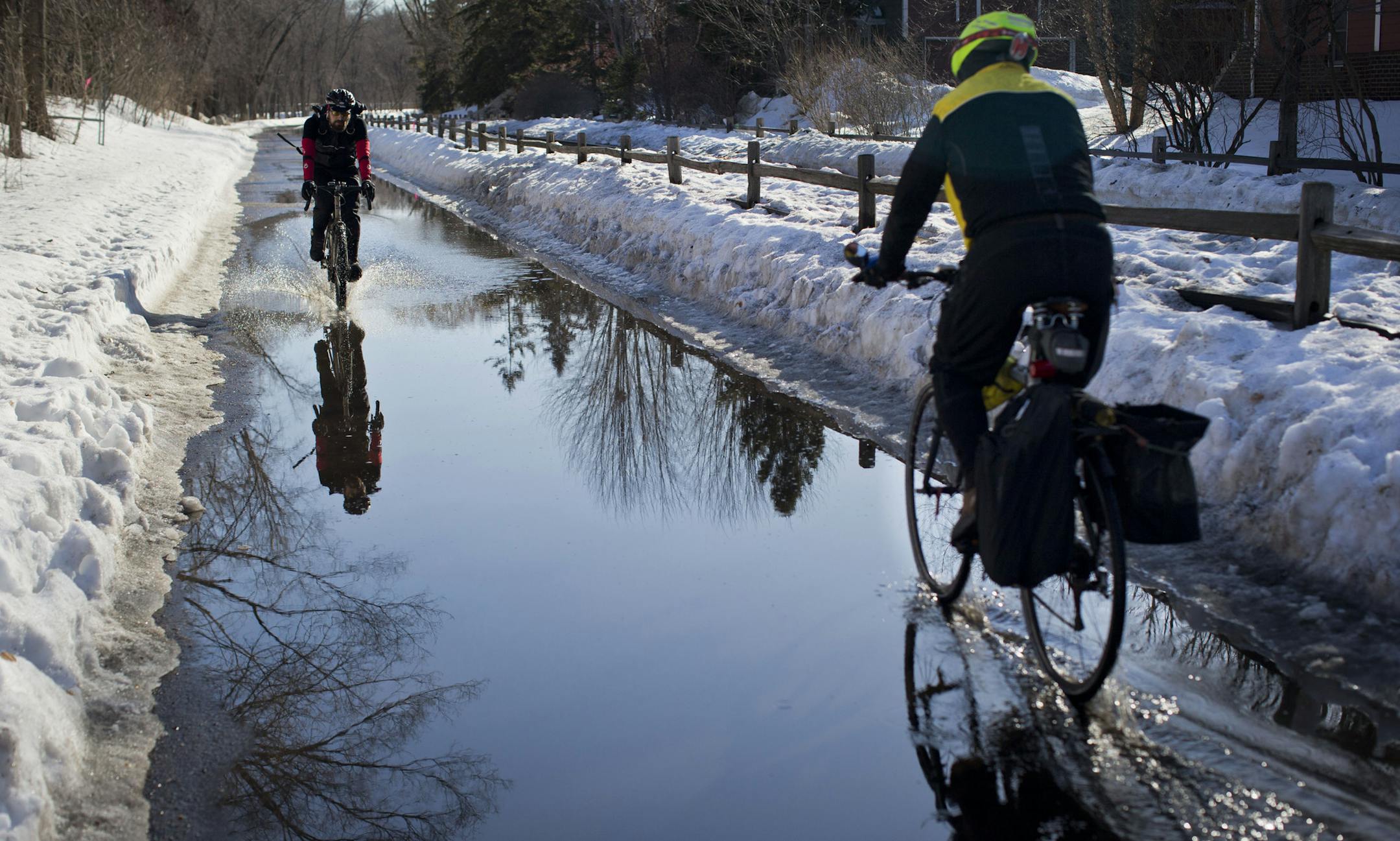 Bicyclists rode through large puddle on the Kenilworth corridor in Minneapolis, Minn., on Thursday, March 13, 2014. ] (RENEE JONES SCHNEIDER &#x2022; reneejones@startribune.com)