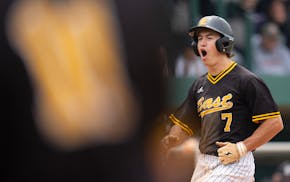 Mankato East outfielder Carson Hart celebrates after scoring off two Delano errors in the third inning.
