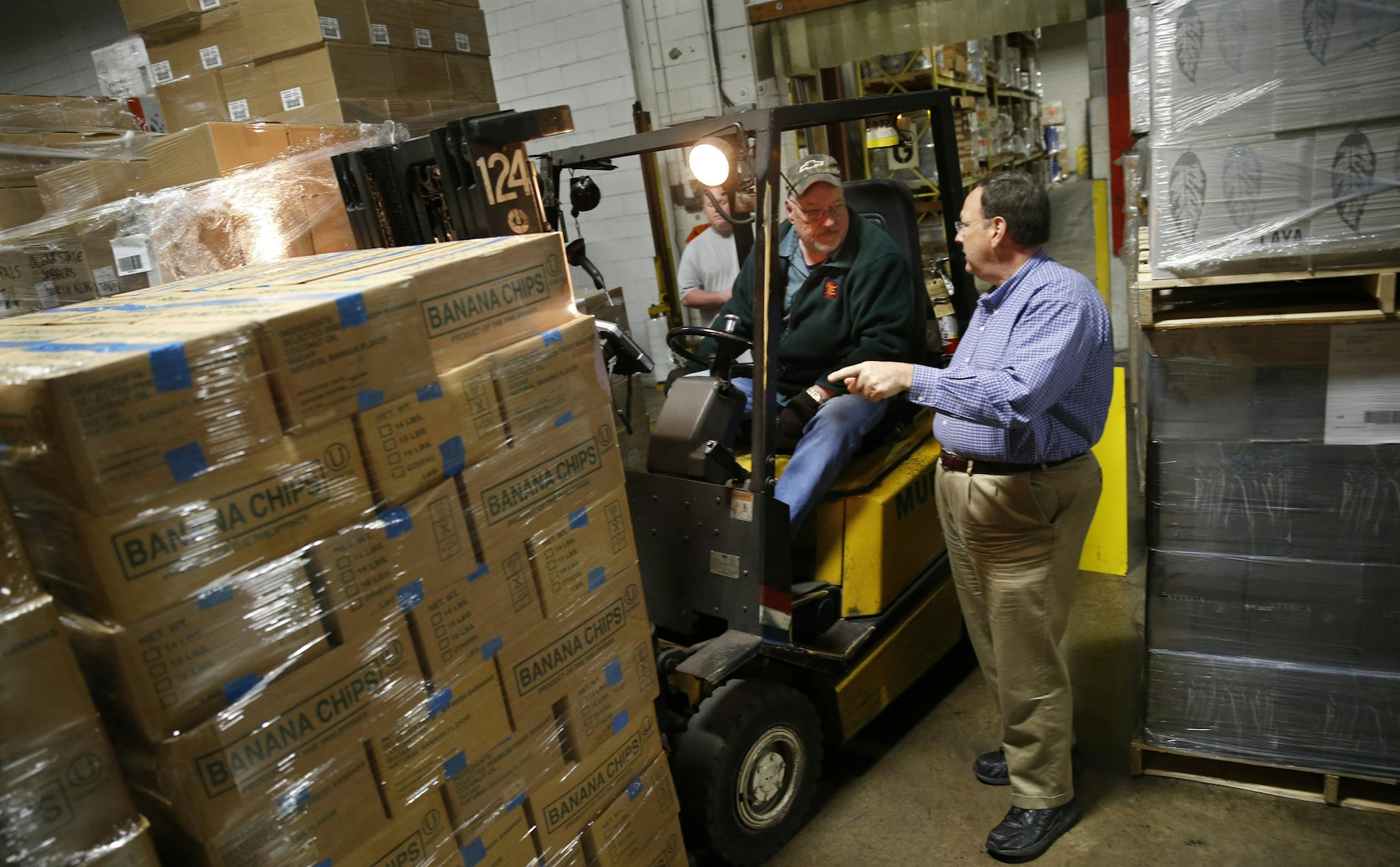 At the Murphy Co. warehouse in Minneapolis, President/CEO Richard T. Murphy Jr. chatted with 38-yr veteran Greg Moose was loading some banana chips used for trail mix by a company in Chicago.] richard tsong-taatarii@startribune.com