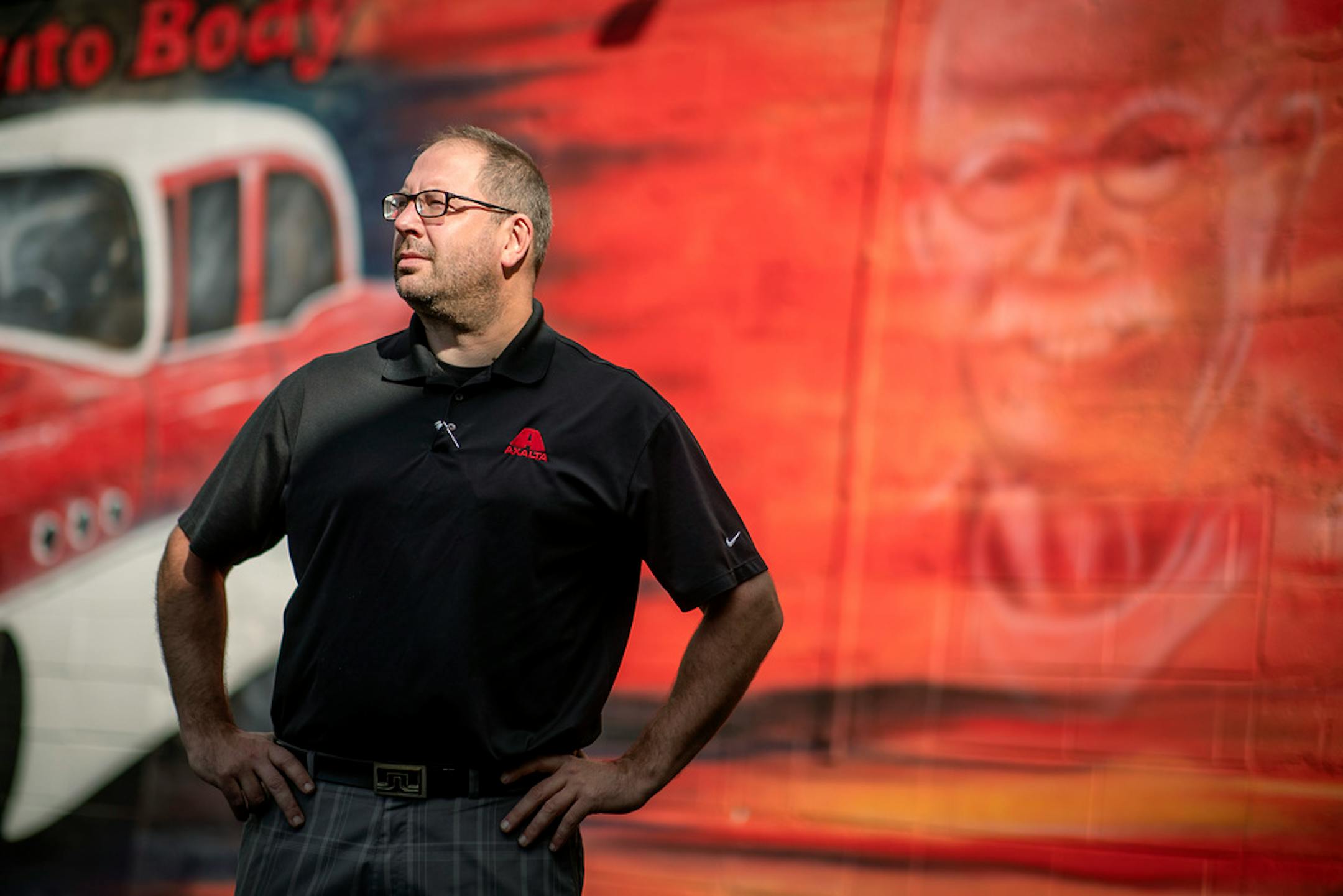 General manager Adam Strom outside the shop, which has a mural featuring former owner Paul Blumer.