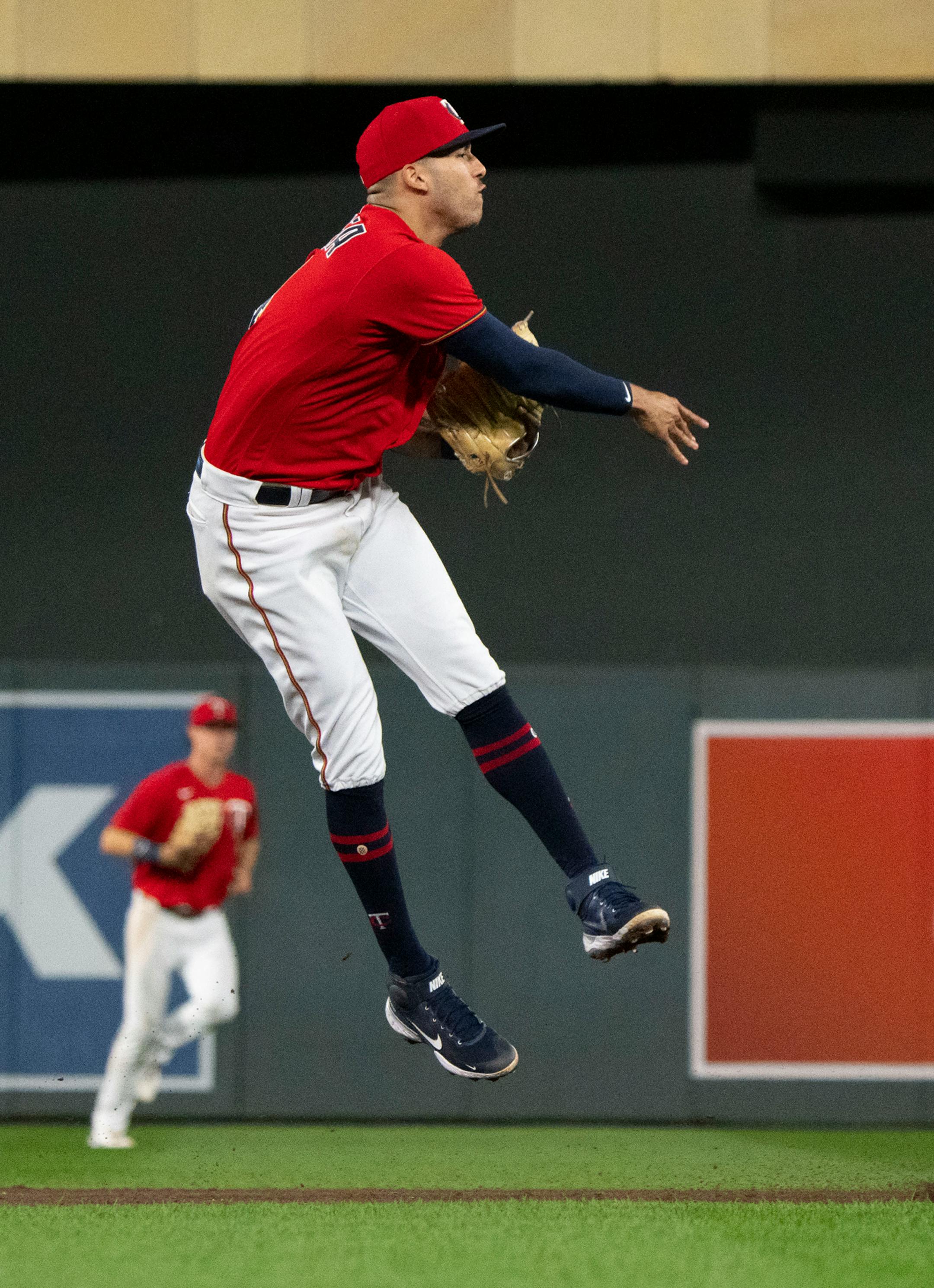 Minnesota Twins shortstop Carlos Correa (4) throws the ball to first for a double play.