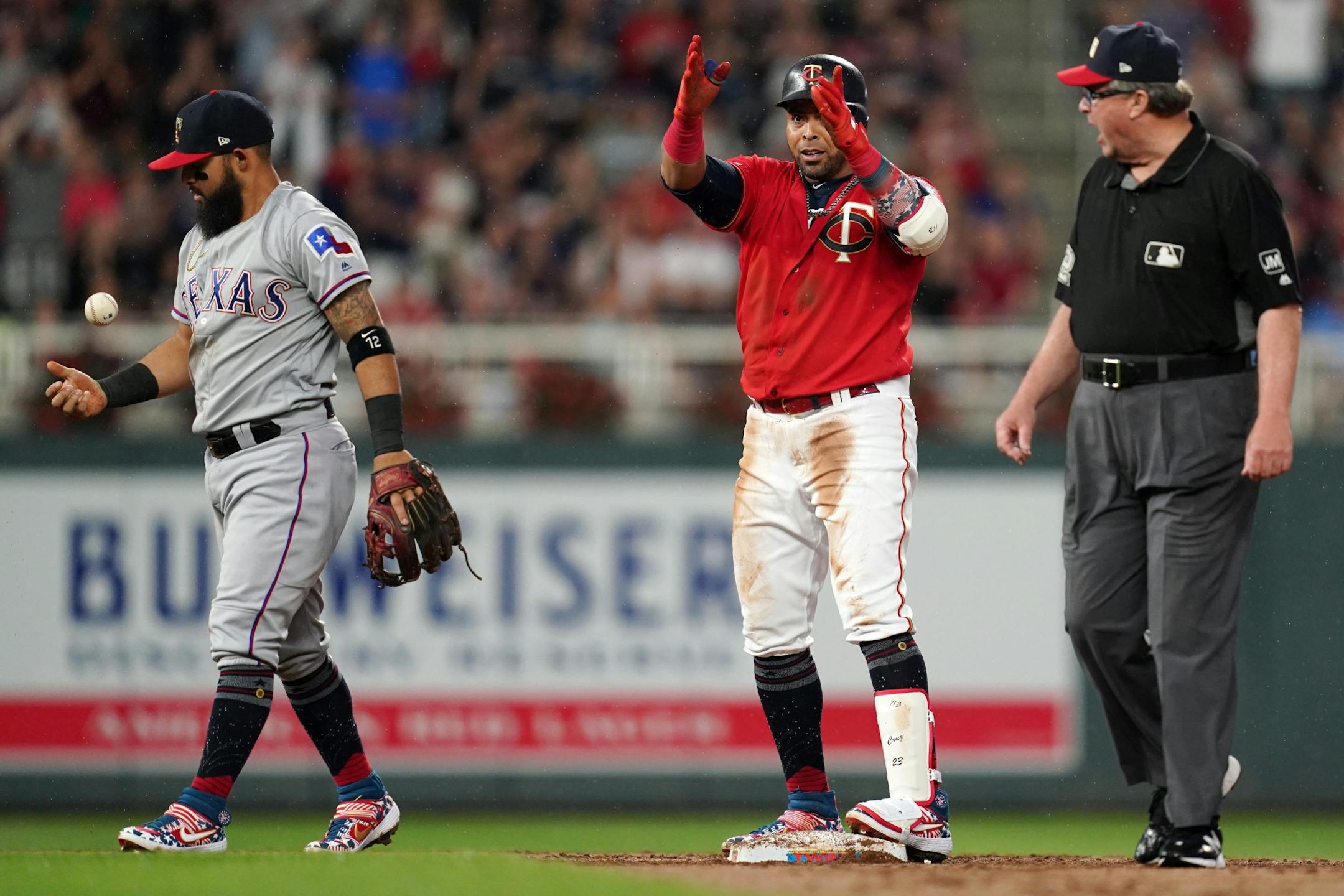 Minnesota Twins designated hitter Nelson Cruz (23) celebrated after beat Texas Rangers second baseman Rougned Odor (12) to the tag at second base for a double in the second inning.