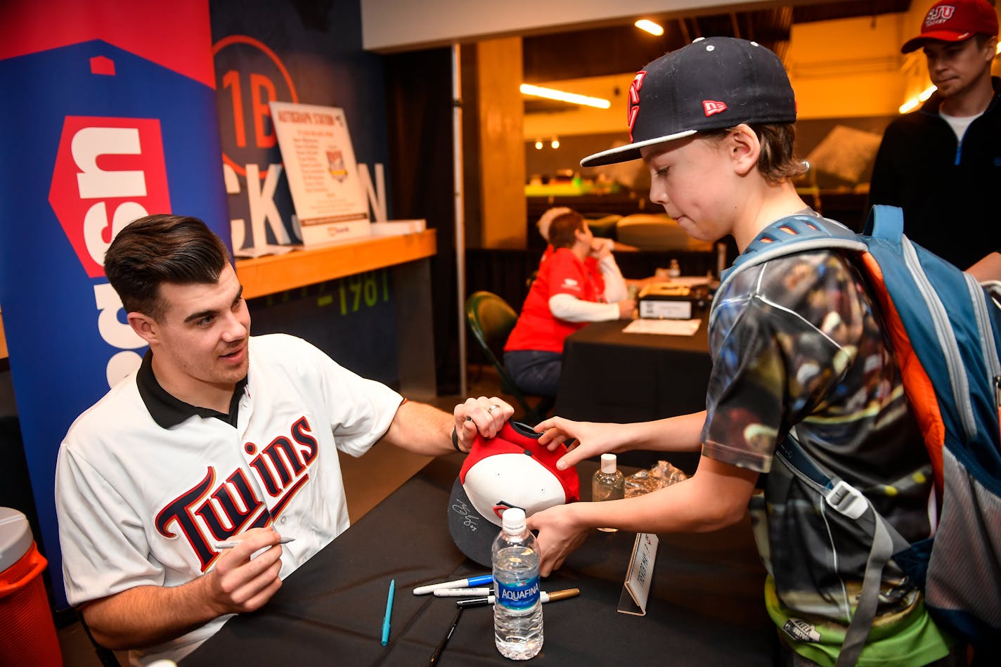 Twins pitcher Trevor May handed a signed hat back to Shepherd Ayshford, 12, of Anoka, during TwinsFest Saturday at Target Field. ] AARON LAVINSKY � aaron.lavinsky@startribune.com Twins pitcher Trevor May signed autographs for fans during Twins Fanfest on Friday, Jan. 27, 2017.