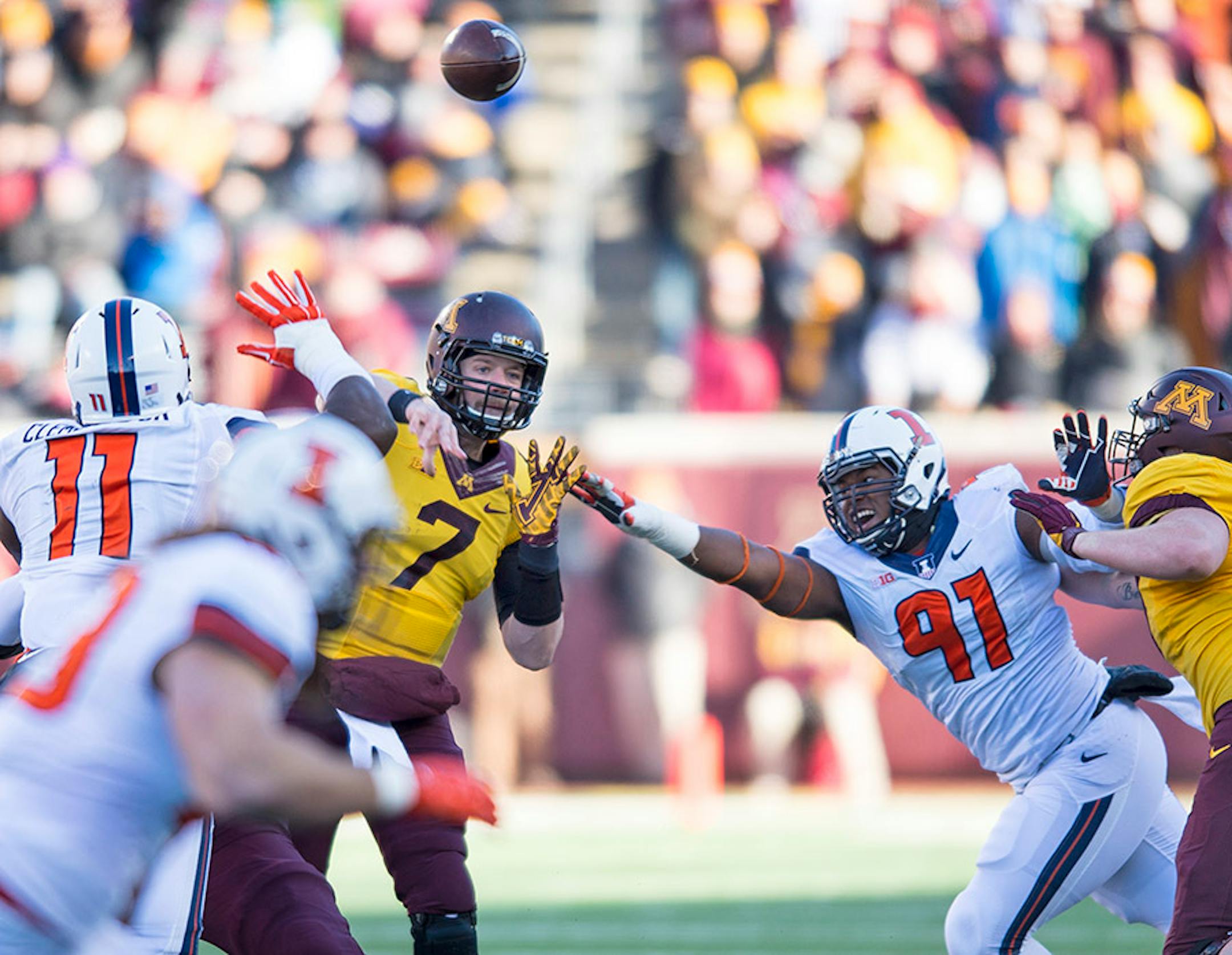 Gophers quarterback Mitch Leidner threw a pass under pressure in the first quarter against Illinois.