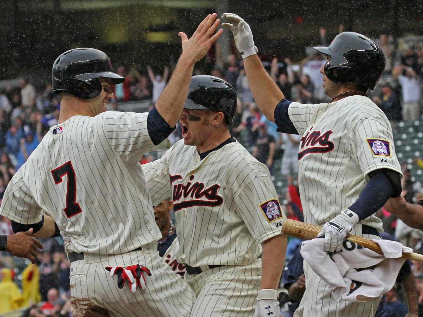 (left to right) Joe Mauer celebrated the winning run on a Ryan Doumit triple, with Chris Parmelee and Chris Colabello in 9th inning action.] Bruce Bisping/Star Tribune bbisping@startribune.com Joe Mauer, Ryan Doumit, Chris Parmelee, Chris Colabello/roster.