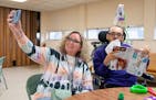 Kathy Ware takes a selfie with her son, Kylen, 29, at a bingo night for adults with developmental disabilities at First Presbyterian Church in St. Pau