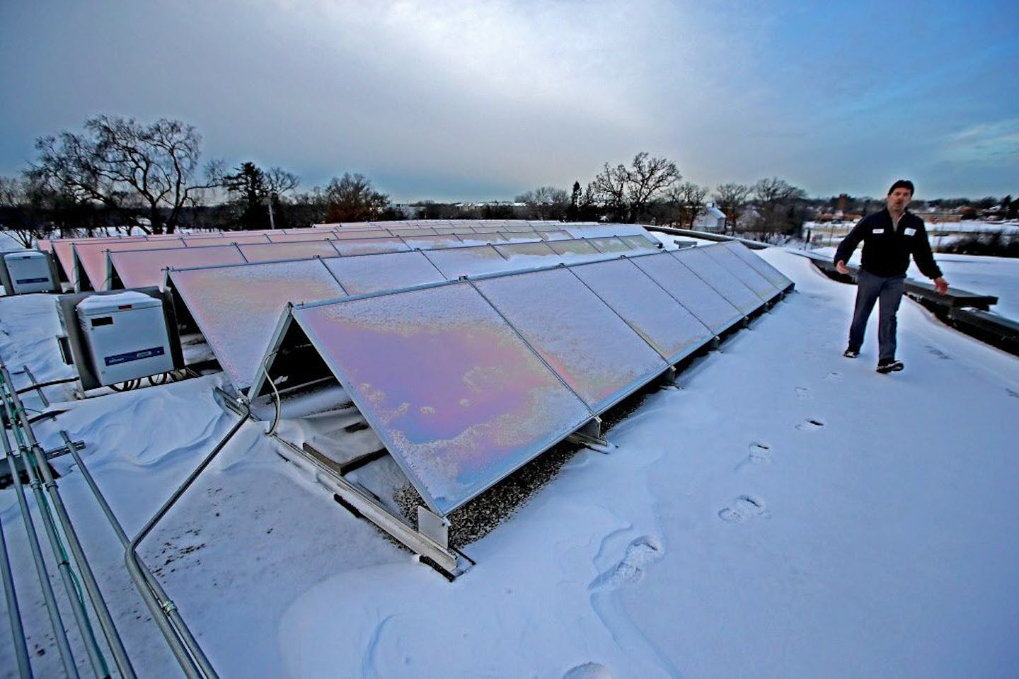 Terry Klapperick, the HVAC specialist for the city of Edina, showed how the new solar panels function on top of the Edina City Hall building, Friday, January 13, 2017.