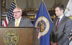 Minnesota Gov. Tim Walz, left, and his economic development commissioner, Steve Grove, right, meet with reporters in the governor's office at the stat