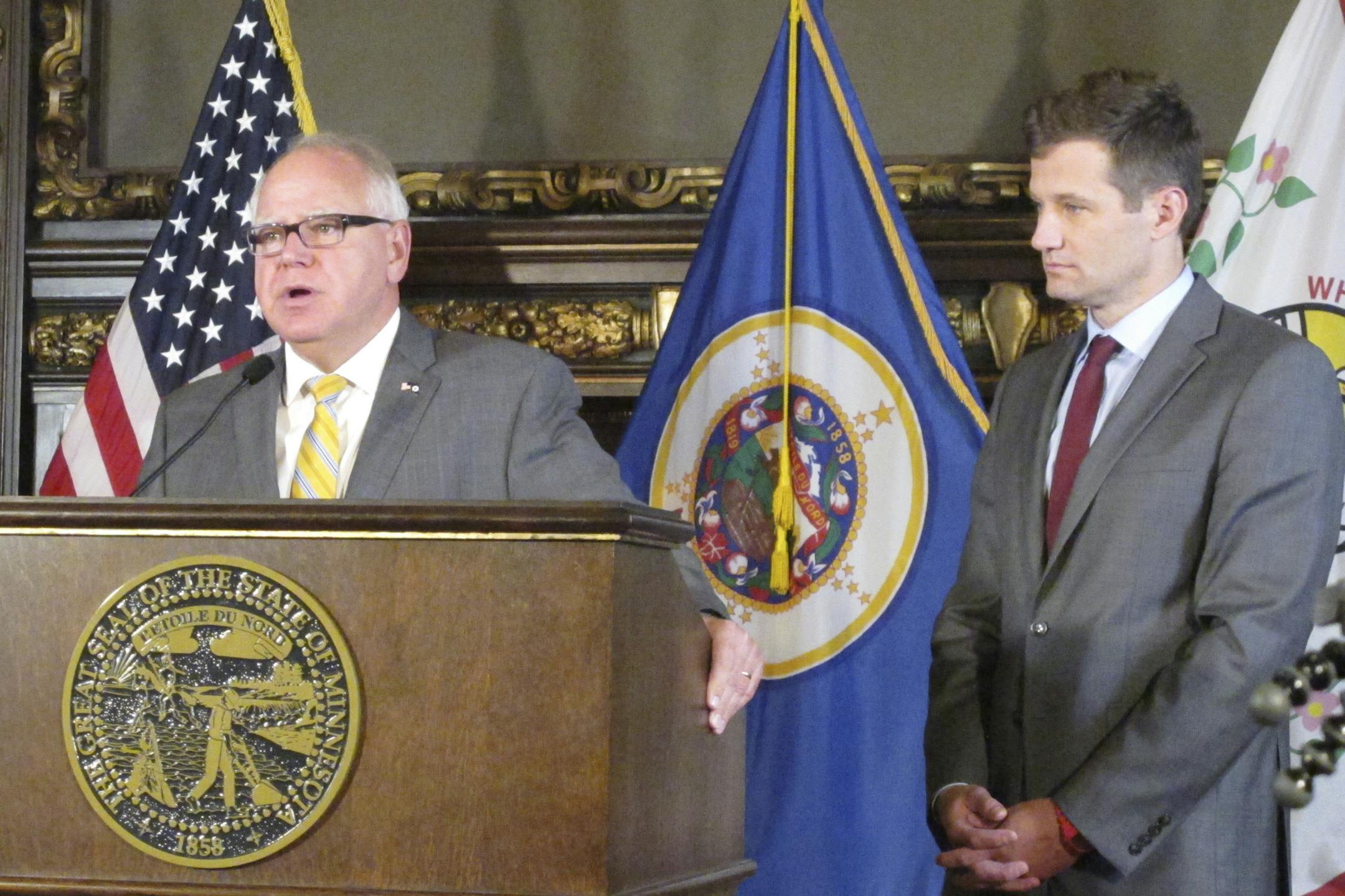 Minnesota Gov. Tim Walz, left, and his economic development commissioner, Steve Grove, right, meet with reporters in the governor's office at the state Capitol in St. Paul, Minnesota, on Friday, Sept. 13, 2019, to discuss their just-ended trade mission to Japan and South Korea. (AP Photo/Steve Karnowski)