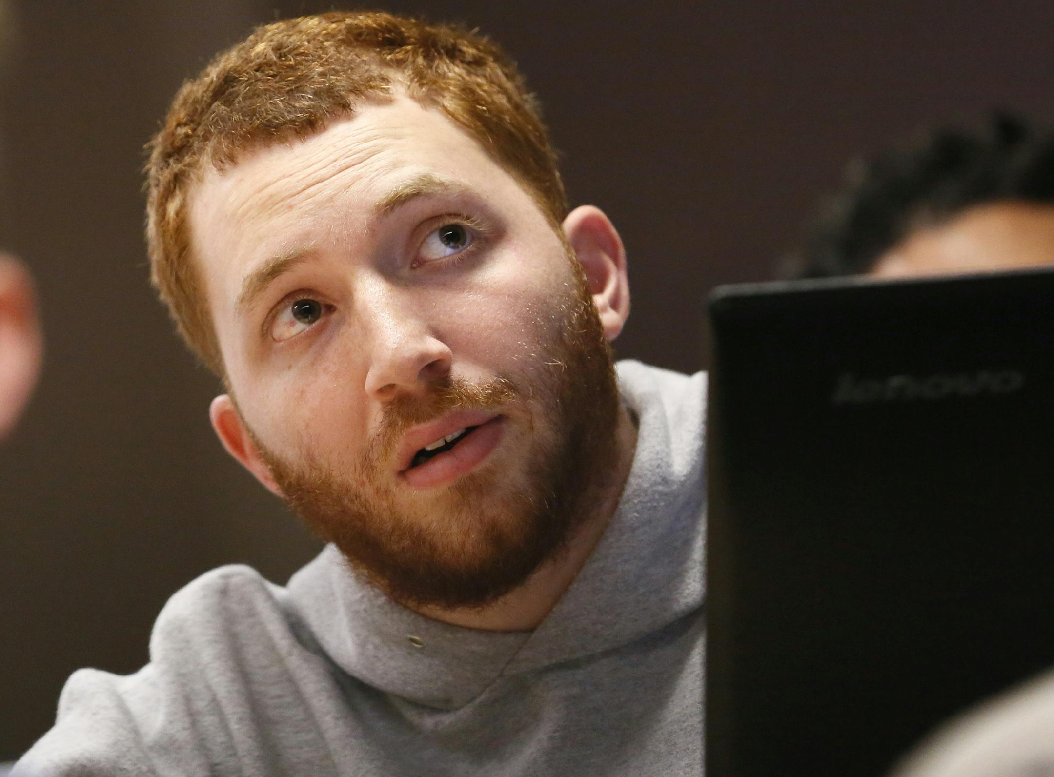 ADVANCE FOR USE SUNDAY, APRIL 24, 2016 AND THEREAFTER - In this Wednesday, March 2, 2016 photo, Ben Alexander listens to a lecture during a class for screenwriting at Tulane University in New Orleans. Alexander has nonverbal autism, a condition that became apparent when he was 2 years old. He has found his voice through writing using what is known as “facilitated communication,” a method in which another person supports the hand of the autistic person so he or she can communicate t