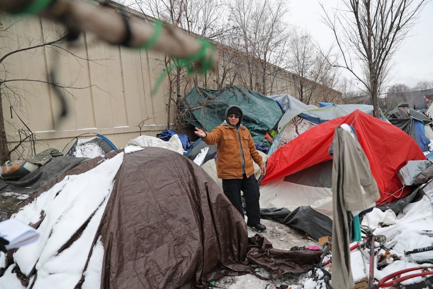 Although people are finding housing and moving away from the homeless camp on Hiawatha, many remain. In this photo, Josue Palacios, pastor of the Iglesia Cristiana Pentecostes Rayo de Luz church in Minneapolis, explained why he has spent every Saturday for the last three months offering assistance and food and coffee at the camp. Previously an EMT, Palacios has offered medical assistance to two people at the camp, including an unresponsive woman who he cared for that morning in the tent behind h