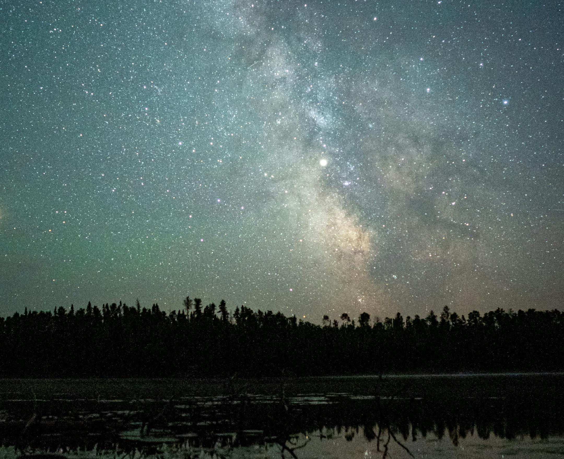 Planets Mars (left) and Saturn (center) shine brightly against the backdrop of the Milky Way above Fire Lake in the Boundary Waters Canoe Area.