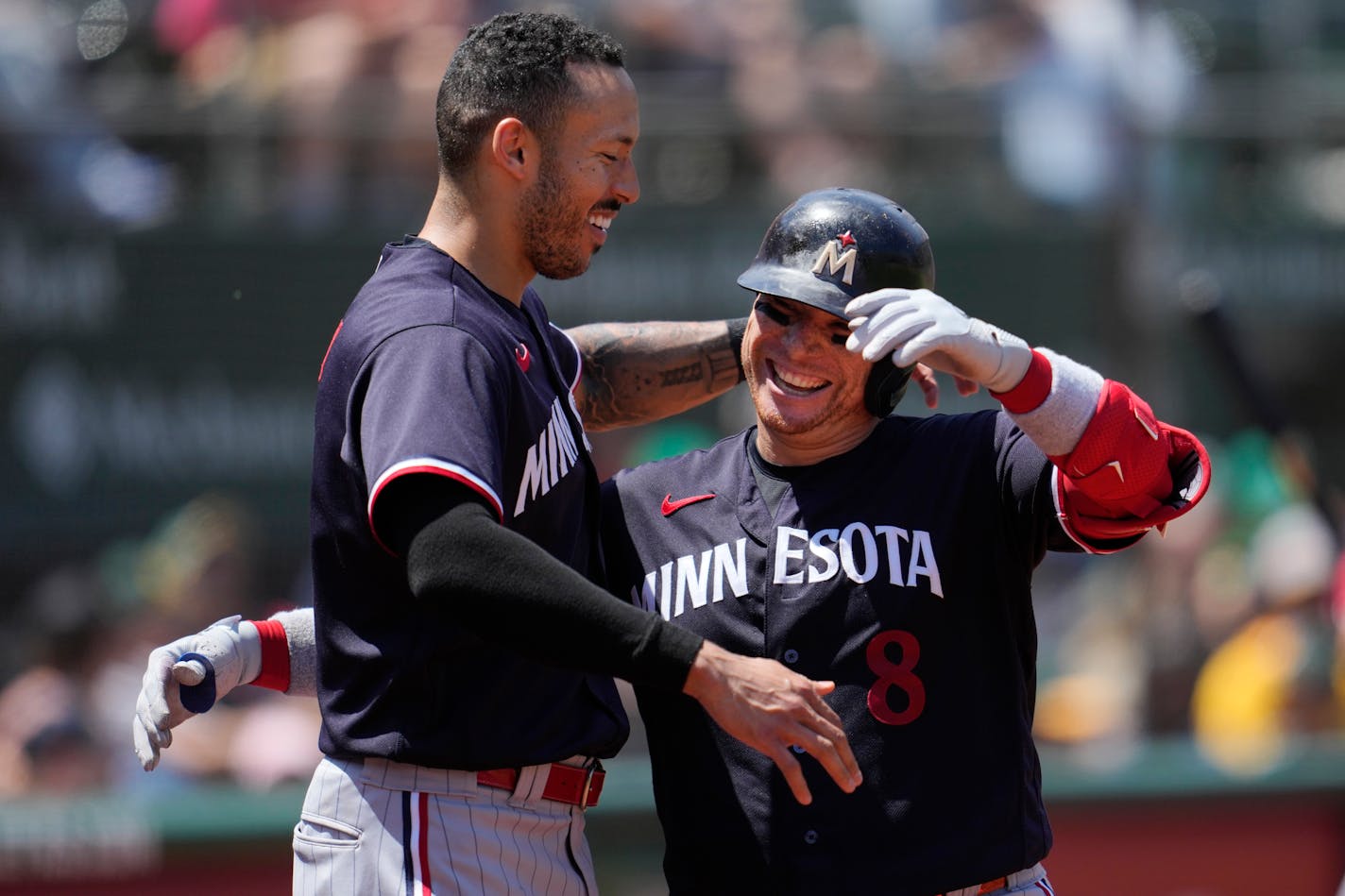 Minnesota Twins' Christian Vazquez, right, is congratulated by Carlos Correa after hitting a home run during the fifth inning of a baseball game against the Oakland Athletics in Oakland, Calif., Sunday, July 16, 2023. (AP Photo/Jeff Chiu)