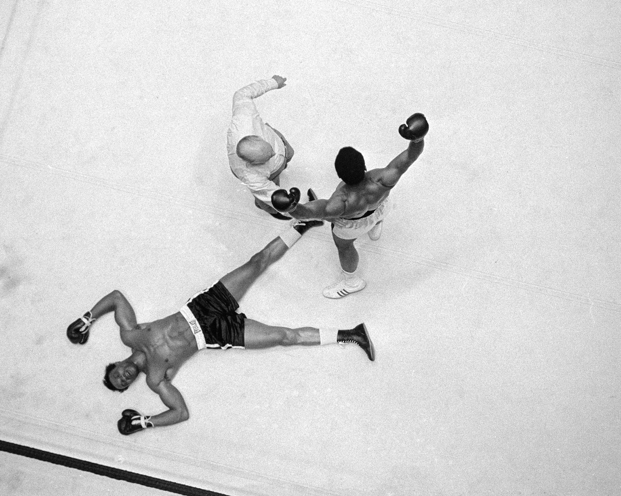 Cleveland Williams is spreadeagled on the canvas as referee Harry Kessler sends Muhammad Ali to a neutral corner during their heavyweight bout at the Astrodome in Houston, Nov. 14, 1966. (AP Photo) ORG XMIT: APHS037534