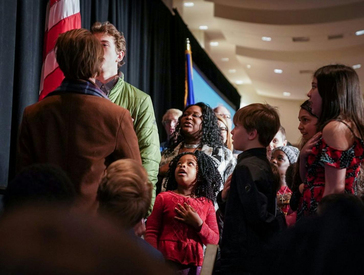 Children helped Minnesota Gov. Tim Walz recite the Pledge of Allegiance during a citizenship ceremony in April in St. Paul.