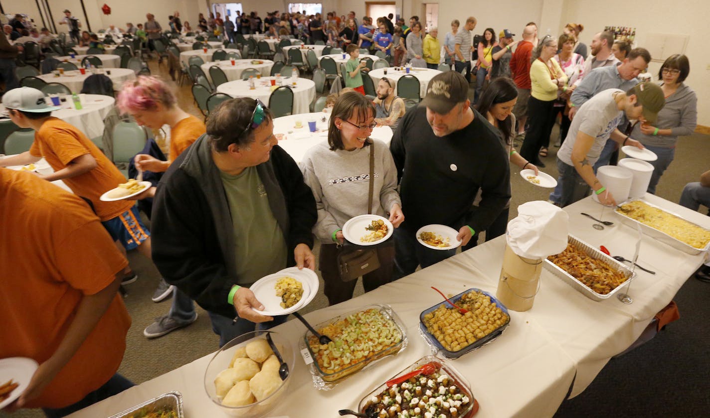 A long lined formed to taste the entries at the Holland Neighborhood's 11th Annual Hotdish Revolution at St Maron's Cedars Hall in Northeast Minneapolis. ] CARLOS GONZALEZ cgonzalez@startribune.com, April 12, 2015, Minneapolis, MN, St Maron's Cedars Hall, Holland Neighborhood's 11th Annual Hotdish Revolution, featuring celebrity judges and music, plus entries into hotdish categories: spicy, vegetarian, tater tot excellence, kids, dar good, fins & feathers. There is also a Jello comptition.