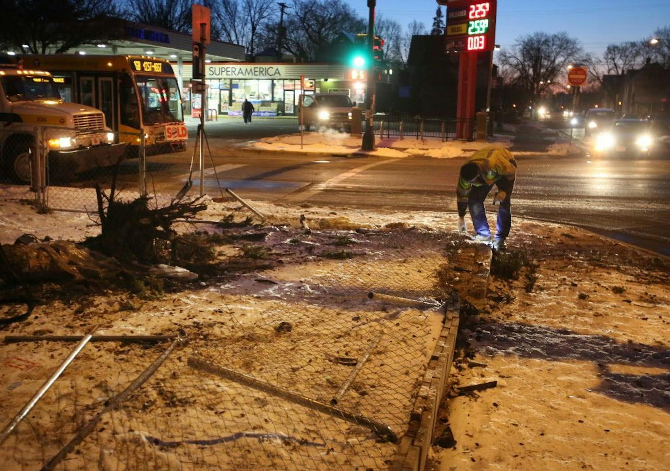 A Metro Transit employee cleaned up crash debris at the corner of 35th St. E. and Nicollet Ave. following an early morning car theft and crash Tuesday, March 14, 2017, in Minneapolis, MN. Two of three suspects in the crash fled the scene and have not yet been apprehended by police.
