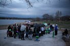 People gathered at a picnic area at Lake Phalen.