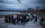 People gathered at a picnic area at Lake Phalen.