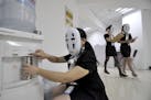 Staff wearing masks during a work day at a property service company specializing in leased office space in Handan in northern China's Hebei province T