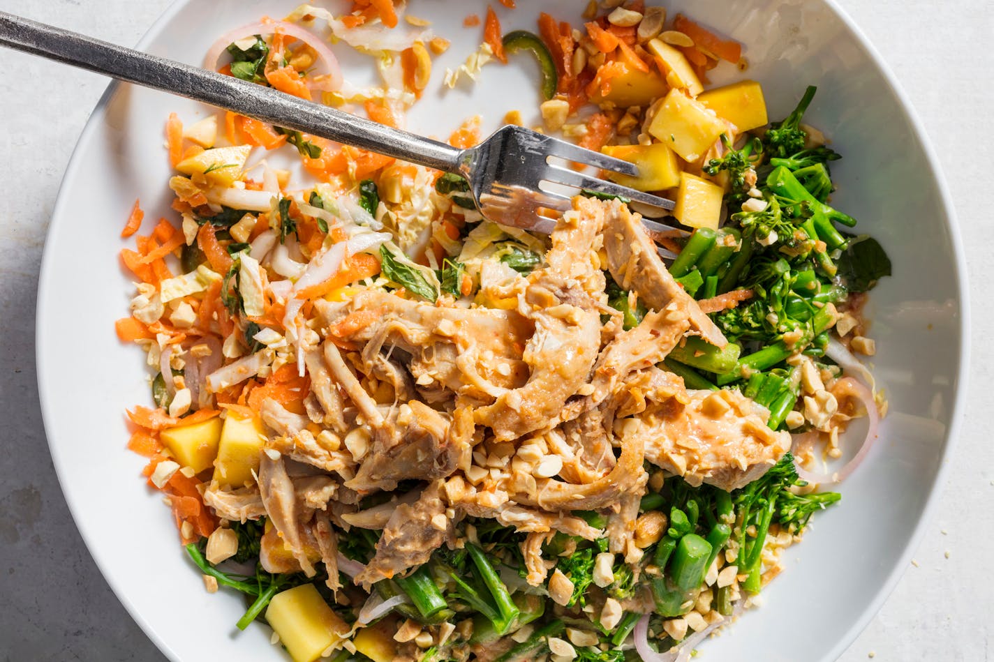 A delicious Hearty Green Salad with Spicy Peanut Chicken from "The Complete Beans & Grains Cookbook" by America's Test Kitchen.