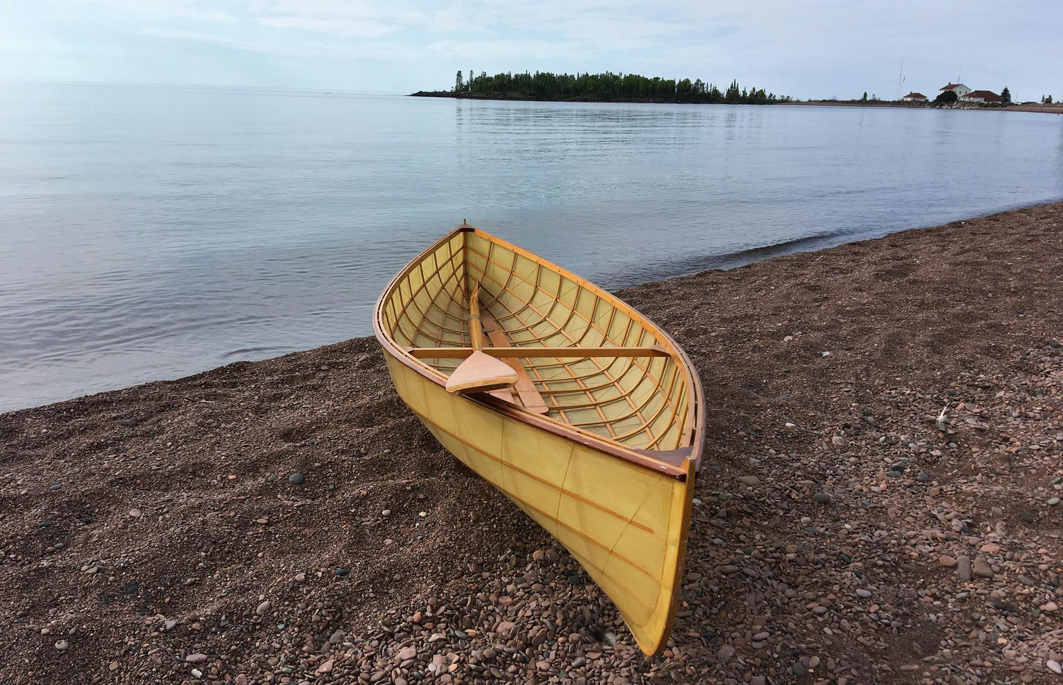 A skin-on-frame canoe named Acushla ready for a paddle on Lake Superior at the North House Folk School's Wooden Boat Show and Summer Solstice Festival in Grand Marais.