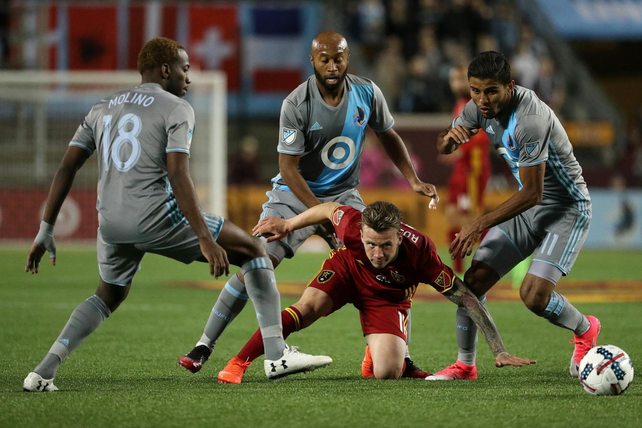 Real Salt Lake midfielder Albert Rusnak (11) went down after being surrounded by Minnesota United defenders in the ball in the second half.